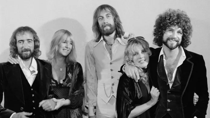 Black-and-white group portrait of the five members of Fleetwood Mac standing together